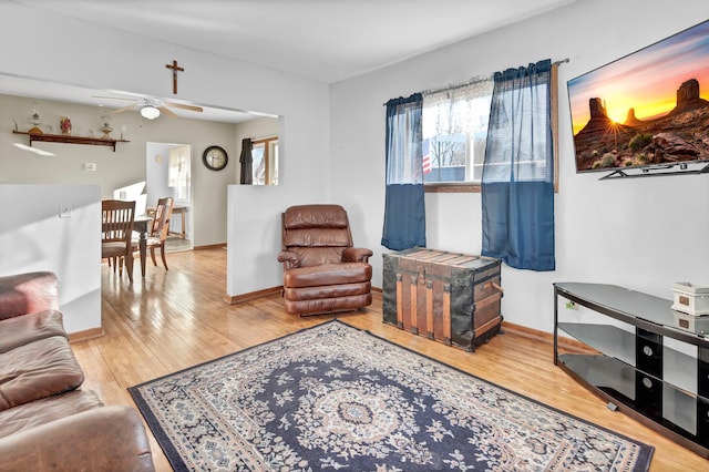 living room featuring hardwood / wood-style flooring and ceiling fan