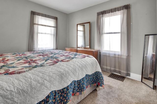 bedroom with carpet flooring and multiple windows