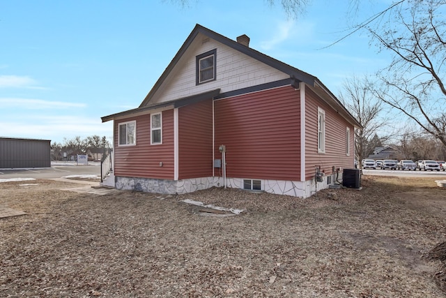 view of side of property featuring central air condition unit