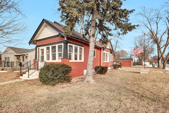 view of side of property with a lawn