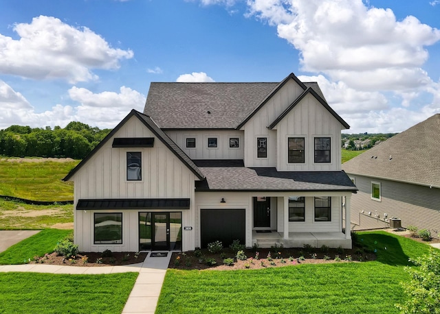 modern inspired farmhouse featuring a front lawn, central air condition unit, and french doors