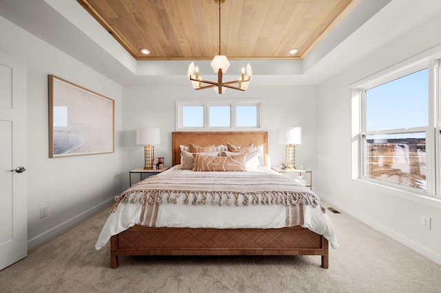 carpeted bedroom featuring a raised ceiling, multiple windows, and wood ceiling