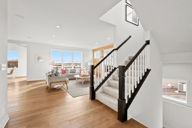 staircase featuring hardwood / wood-style floors and a wealth of natural light