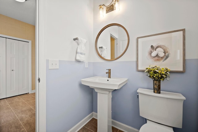 bathroom featuring tile patterned flooring and toilet