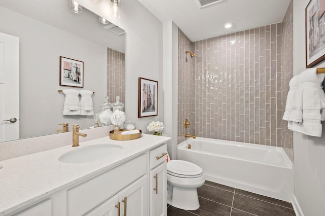 full bathroom with vanity, tiled shower / bath combo, and toilet