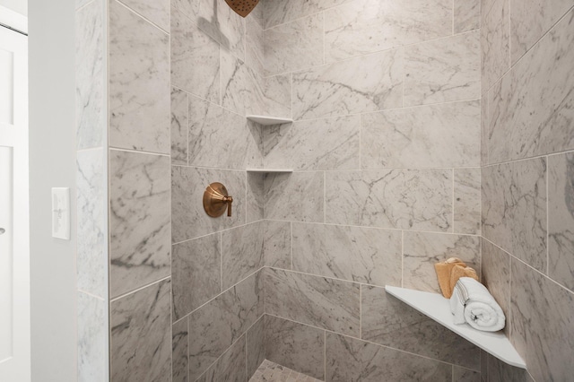 bathroom with a tile shower