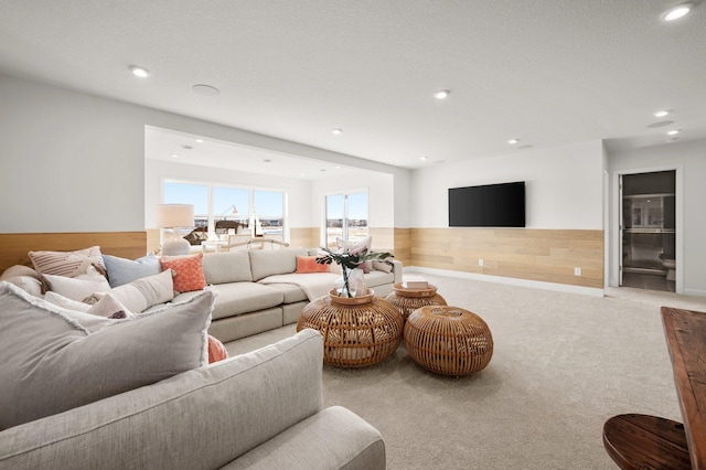 living room featuring light carpet and wooden walls