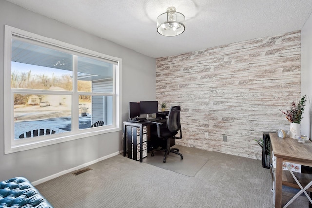 carpeted office space with wooden walls and a textured ceiling