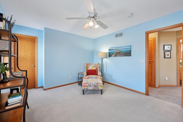 sitting room with light colored carpet and ceiling fan