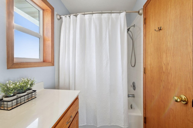 bathroom featuring vanity and shower / bath combo with shower curtain