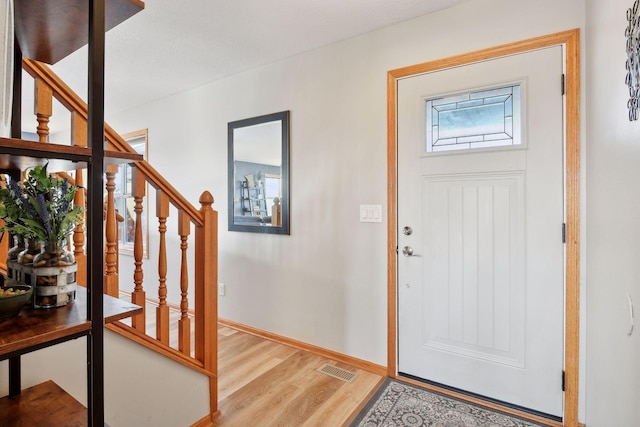 foyer entrance with wood-type flooring