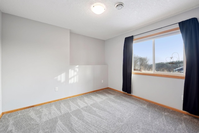 spare room with carpet floors and a textured ceiling