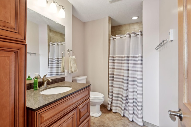 bathroom with vanity, a textured ceiling, a shower with curtain, and toilet