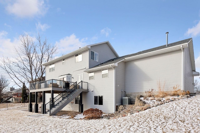 snow covered house featuring a deck