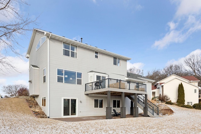 rear view of property featuring a deck