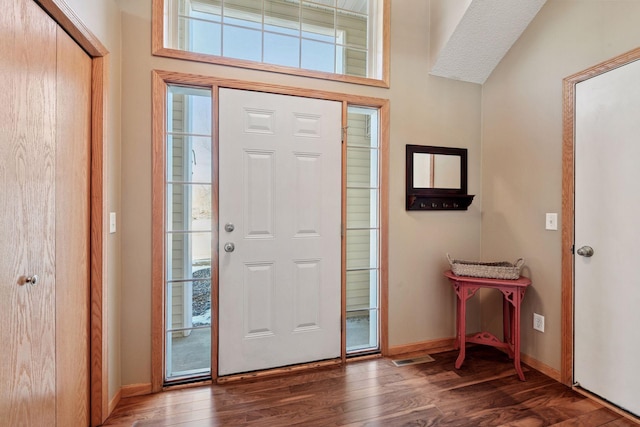 entrance foyer with baseboards and wood finished floors