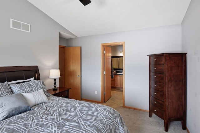 bedroom with baseboards, visible vents, vaulted ceiling, light carpet, and connected bathroom