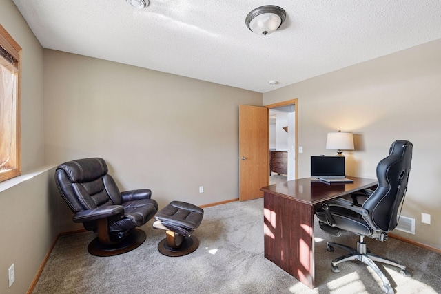 office area with visible vents, baseboards, carpet floors, and a textured ceiling