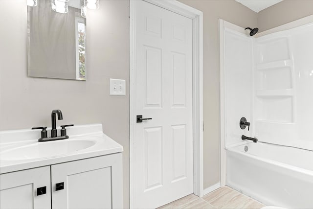 bathroom featuring bathtub / shower combination and vanity