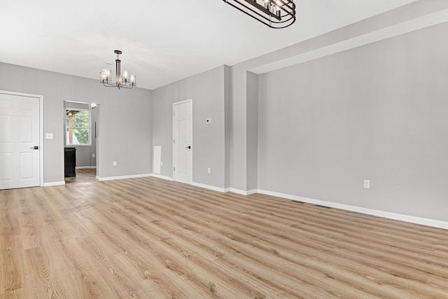 interior space with a chandelier and light hardwood / wood-style floors