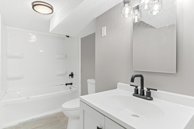 full bathroom featuring vanity, toilet, a textured ceiling, and shower / washtub combination