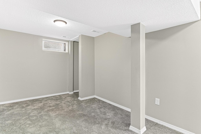 basement with carpet flooring and a textured ceiling