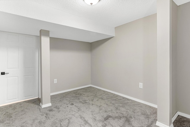 basement featuring carpet and a textured ceiling