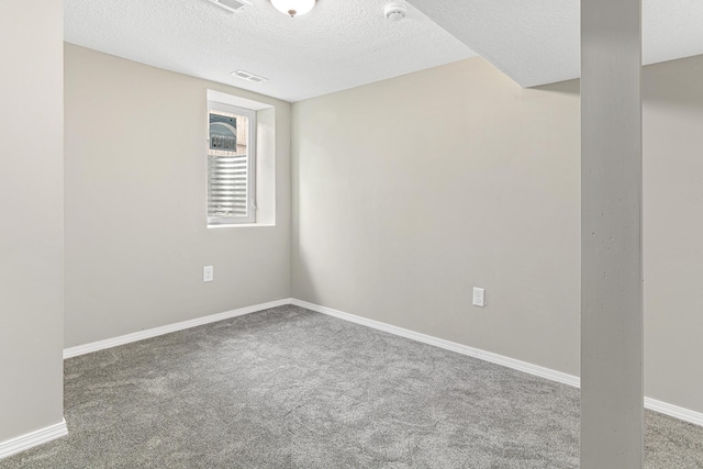 spare room with carpet and a textured ceiling