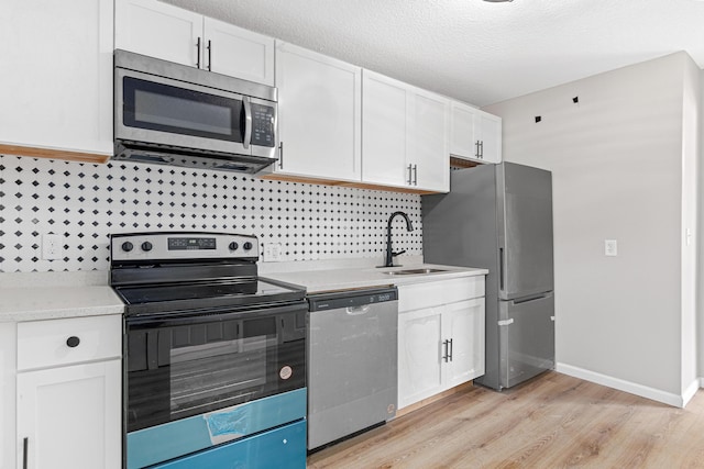 kitchen with white cabinetry, sink, and stainless steel appliances