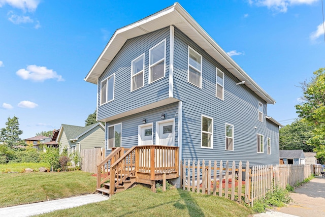 rear view of property with a yard