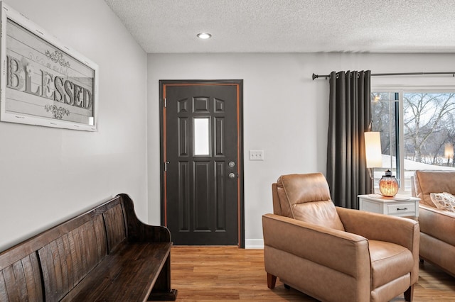 sitting room featuring light hardwood / wood-style floors and a textured ceiling