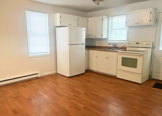 kitchen featuring light wood-type flooring, white appliances, baseboard heating, sink, and white cabinetry