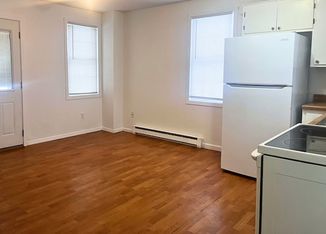 kitchen with hardwood / wood-style floors, stove, white cabinets, white refrigerator, and baseboard heating