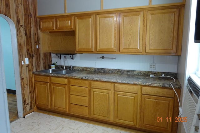 kitchen featuring sink and dark stone countertops