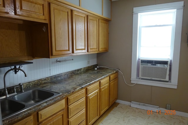 kitchen featuring sink, cooling unit, and dark stone countertops