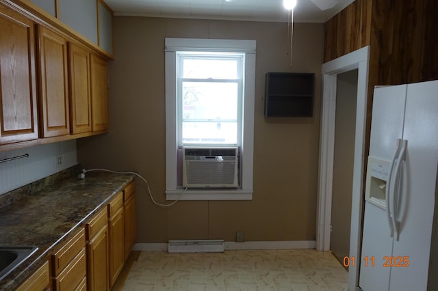 kitchen with ceiling fan, cooling unit, dark stone countertops, white refrigerator with ice dispenser, and sink