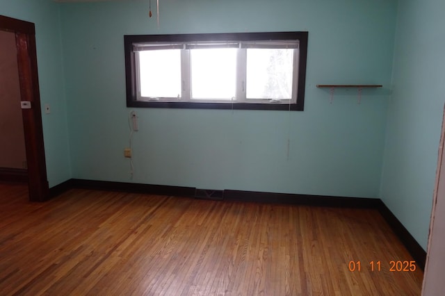 empty room with wood-type flooring