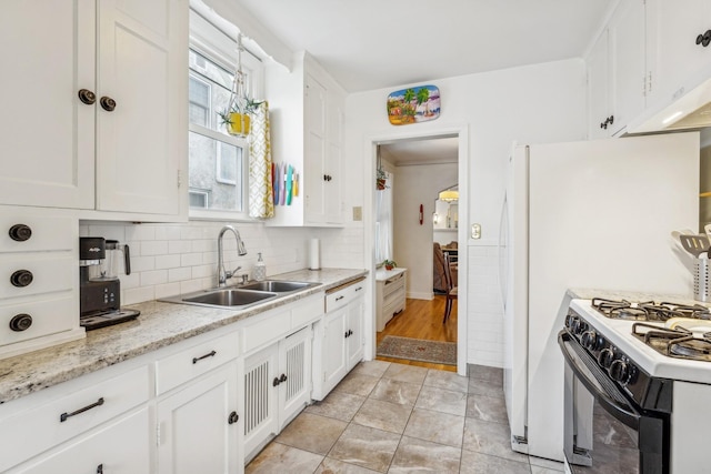 kitchen featuring sink, white cabinetry, and plenty of natural light