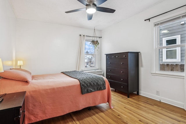 bedroom with ceiling fan and light hardwood / wood-style floors