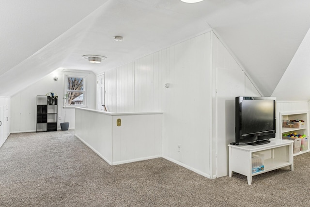 bonus room featuring vaulted ceiling and carpet flooring