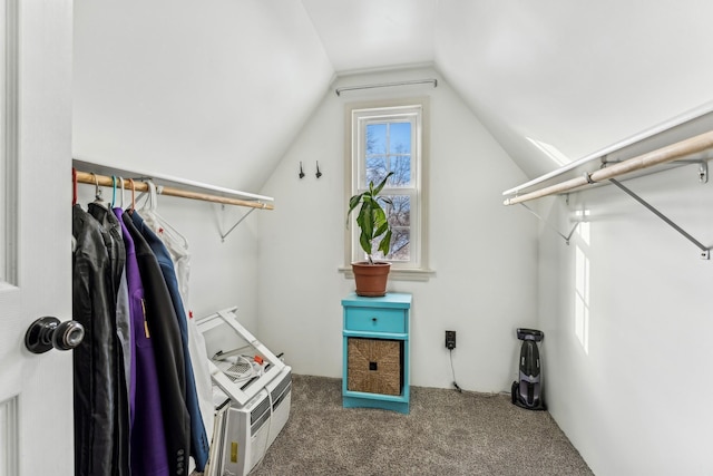 walk in closet with carpet and vaulted ceiling