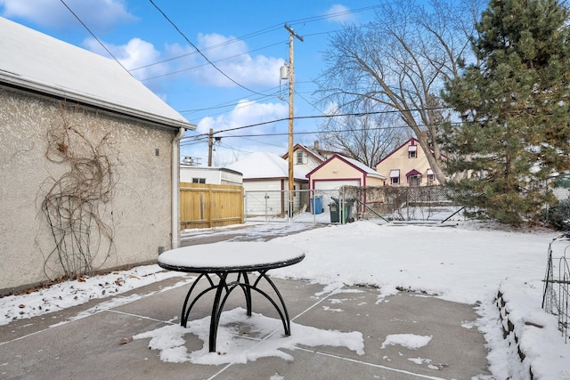 yard covered in snow featuring a garage