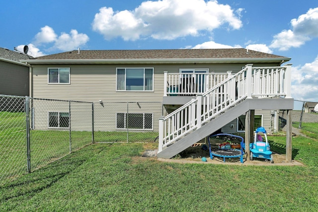 back of property featuring a lawn and a wooden deck