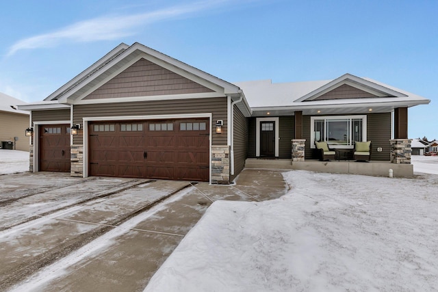 craftsman inspired home with covered porch and a garage