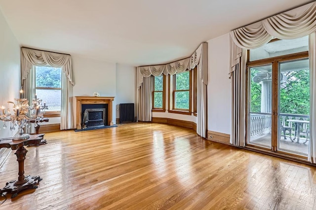 442 Summit Ave Unit 6, Saint Paul, MN 55102 - unfurnished living room featuring healthy amount of natural light, light wood-type flooring, and a fireplace with flush hearth