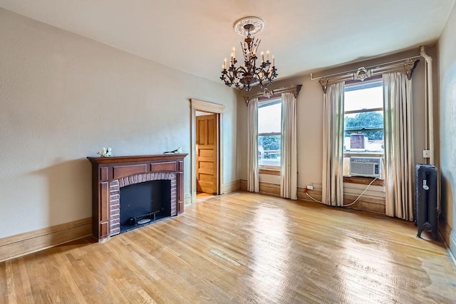 442 Summit Ave Unit 6, Saint Paul, MN 55102 - unfurnished living room with wood finished floors, a chandelier, cooling unit, and a brick fireplace