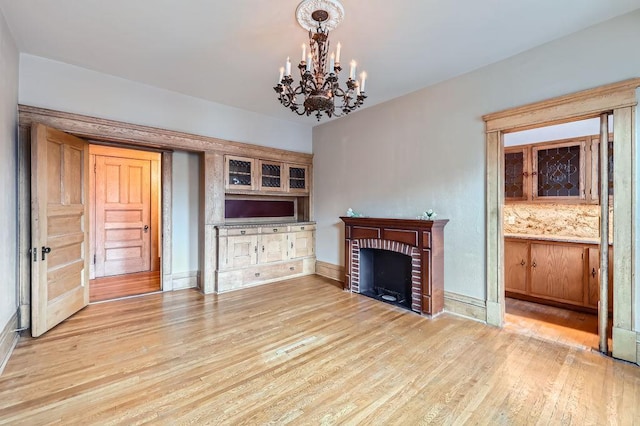 442 Summit Ave Unit 6, Saint Paul, MN 55102 - unfurnished living room with a chandelier, light wood finished floors, and a fireplace