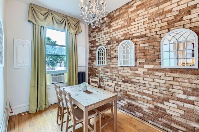 442 Summit Ave Unit 6, Saint Paul, MN 55102 - dining area with brick wall, a chandelier, light wood finished floors, and cooling unit