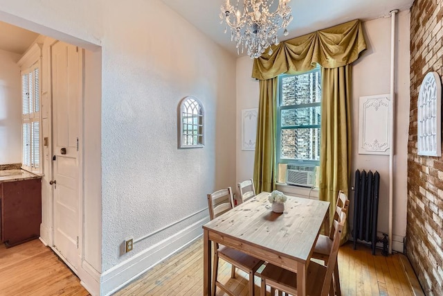 442 Summit Ave Unit 6, Saint Paul, MN 55102 - dining room with radiator heating unit, a chandelier, plenty of natural light, and a textured wall