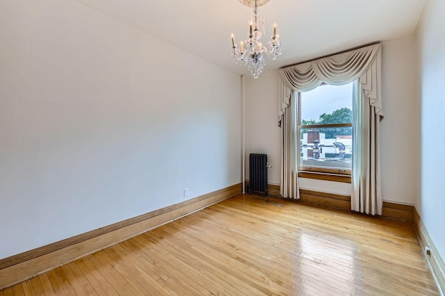 442 Summit Ave Unit 6, Saint Paul, MN 55102 - unfurnished room featuring radiator heating unit, a chandelier, and light wood-style flooring